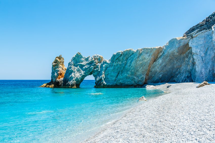 Famous hole in the rock formation at Lalaria beach, Skiathios island, Greece.
